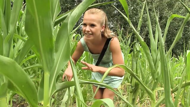 Sexy blond lesbians kissing and dildo toying in field