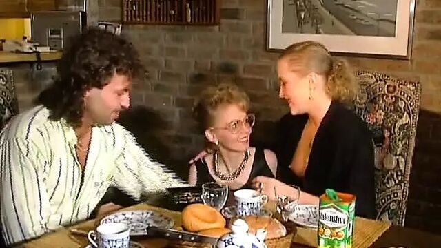 Two stunning German chicks sharing a loaded cock on the kitchen table