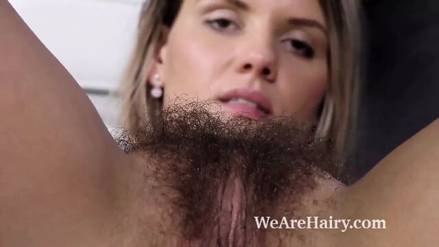 Jehanna strips naked and fingers her hairy pussy